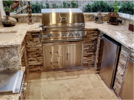 Close-up of outdoor kitchen with RCS grill, granite counters and ledgestone base