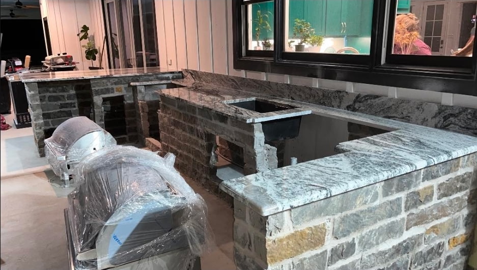 Wrap-around outdoor bar with granite counters under construction